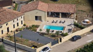 an aerial view of a house with a swimming pool at Repaire - Le Repaire de Maltus "Gîtes & Spa" in Lussac