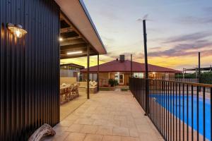 a house with a balcony with a swimming pool at Dune Break in Exmouth