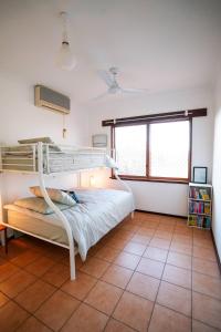 a bedroom with a bunk bed and a large window at Dune Break in Exmouth +34 photos