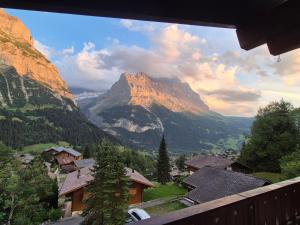 a view of a mountain and a village in a valley at ABO - Boutique Apartment - Chalet Horst in Grindelwald