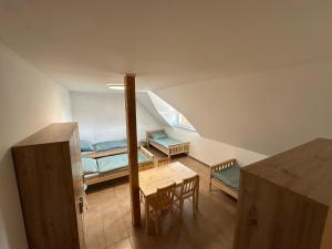 a small room with a table and a bed at Vila Stella Vita in Chrbonín