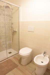 a bathroom with a toilet and a shower and a sink at Casa Nora in Valsinni