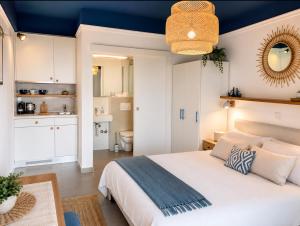 a bedroom with a white bed and a blue ceiling at Villa Tamaris on the beach in Podstrana
