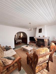 a living room with two couches and a fireplace at La maison de mamy in Bray-Dunes