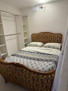 a bed sitting in a room with a bed sqor at Ground-Floor Apartment With private Garden in Étampes