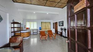 a living room with a table and chairs at Agta Beach Resort in Biliran