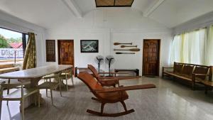a living room with a wooden table and chairs at Agta Beach Resort in Biliran