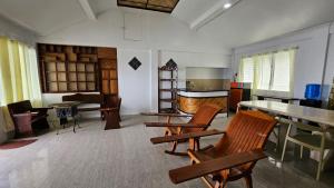 a living room with wooden chairs and a table at Agta Beach Resort in Biliran +46 photos