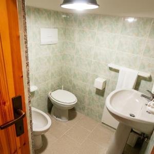 a bathroom with a toilet and a sink at Borgo Moderno in Irgoli
