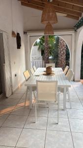 a white table and chairs on a patio at Casa El Mirador in Calpe