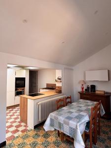 a kitchen and dining room with a table and a kitchen and a table and chairs at La maison de mamy in Bray-Dunes