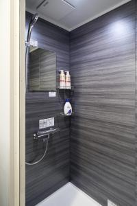 a shower in a bathroom with a black wall at Inside Sangreen - Vacation STAY 22712 in Tokyo +36 photos