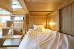 a bedroom with a bed in a wooden room at Inside Sangreen - Vacation STAY 22714 in Tokyo