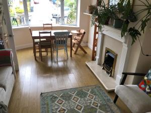 a living room with a fireplace and a table and chairs at Dryden Gardens in Edinburgh