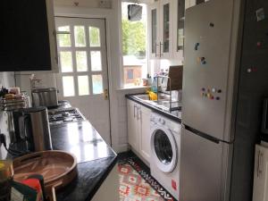 a kitchen with a refrigerator and a washing machine at Dryden Gardens in Edinburgh +6 photos