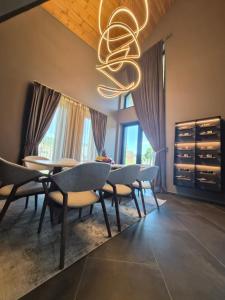 a dining room with chairs and a chandelier at Monte SPA Villas in Banya