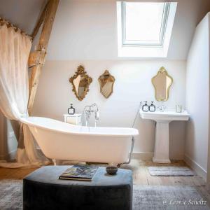 a bathroom with a bath tub and a sink at Château de Najade in Sainte-Sévère-sur-Indre +72 photos