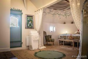 a bedroom with a bed and a desk and a table at Château de Najade in Sainte-Sévère-sur-Indre
