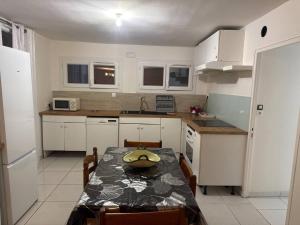 a kitchen with a table and a dining room at Ground-Floor Apartment With private Garden in Étampes