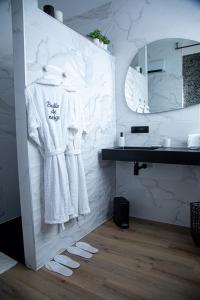 a bathroom with white towels and a mirror at Les alouettes in Caudry