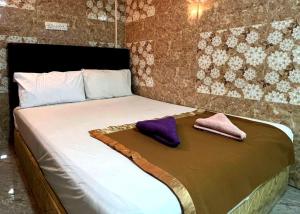 a bedroom with a bed with two pillows on it at New Wave Damansara Damai in Petaling Jaya