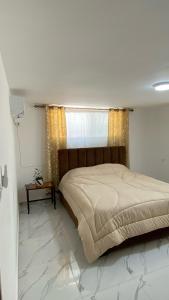 a bedroom with a large bed and a window at W3 property in Kerak
