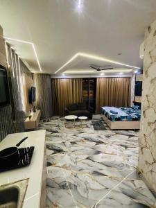a hotel room with a bed and a living room at Nior luxury stays in Ghaziabad