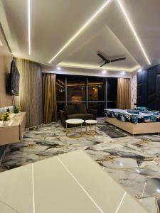 a living room with a bed and a couch at Nior luxury stays in Ghaziabad