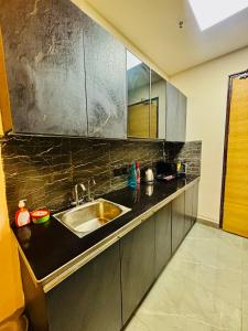 a kitchen with a sink and a counter top at Nior luxury stays in Ghaziabad