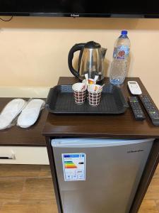 a counter with a tray on top of a refrigerator at AL NAHAR AL KHALEd in Aqaba +49 photos