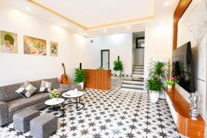 a living room with a couch and tables at Sweet Apartment Sa Pa in Sapa