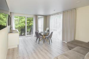 a living room with a table and a couch at 2rest in Palanga