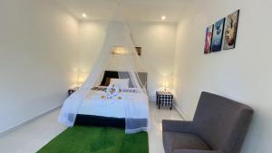 a bedroom with a bed with a mosquito net at The Winaposa in Munduk