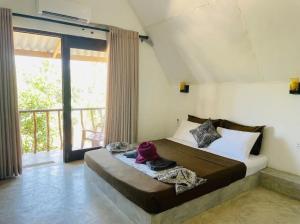 a bedroom with a bed and a large window at Sambu Cabana Panama in Panama