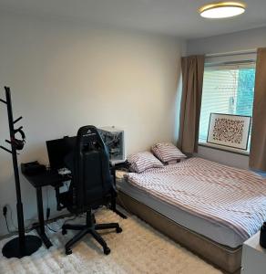 a bedroom with a bed and a desk and a chair at Kotikolo in Pori