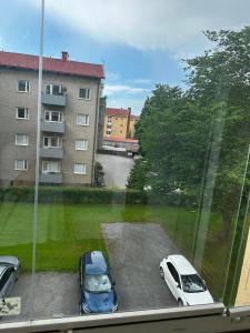 two cars parked in a parking lot next to a building at Kotikolo in Pori
