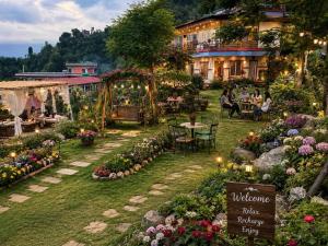 a garden with people sitting around tables and flowers at Fewa View Cottage Yoga Retreat Pokhara in Pokhara