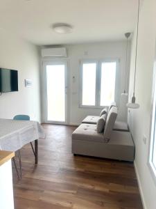 a white room with a bed and two windows at Arcimboldo 1 apartment in San Canzian dʼlsonzo