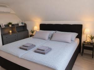 a bed with two pillows on it in a bedroom at Ferienhaus Sonnendeck in Simmerath