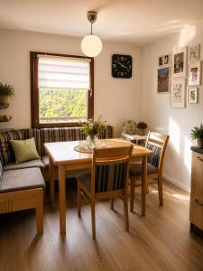 a dining room with a table and a couch at Ferienhaus Sonnendeck in Simmerath +17 photos