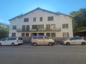 three cars parked in a parking lot in front of a building at La Bulle d Ax in Ax-les-Thermes