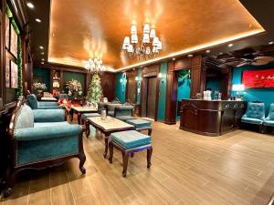 a living room with blue furniture and a bar at Tulip Hotel 2 in Da Lat