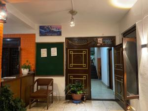 a room with a door and a table and a chair at Sun Rise Cottage in Kathmandu