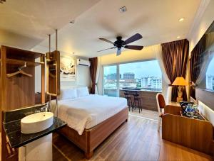 a bedroom with a bed and a sink and a window at Tulip Hotel 2 in Da Lat