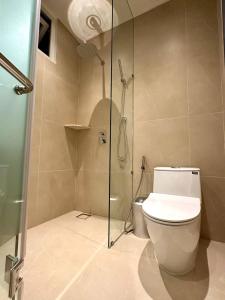 a bathroom with a toilet and a glass shower at Tulip Hotel 2 in Da Lat +32 photos