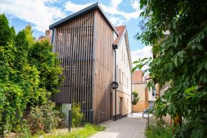 a building with a wooden wall on a street at CASTLE apartments Premium - City Center in Spišské Podhradie
