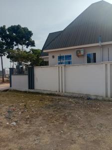 a white fence in front of a house at Nelca Executive Lodge in Mwanza +7 photos