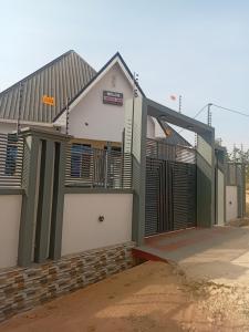 a house with a green and white at Nelca Executive Lodge in Mwanza
