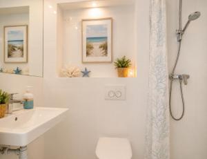 a bathroom with a sink and a toilet and a shower at Villa Tamaris on the beach in Podstrana +14 photos