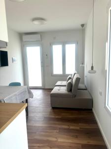a white room with a bed and two windows at Arcimboldo 2 apartment in San Canzian dʼlsonzo +7 photos